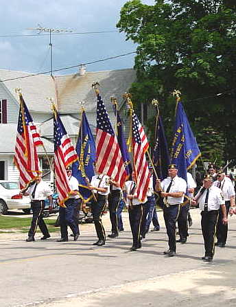 Photo of American Legion group marching in Sweet Corn Days parade in Lime Springs, Iowa.