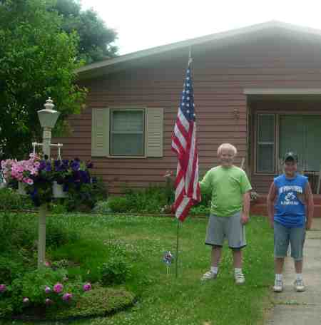 Photo of Junior Community Club members installing American flag.